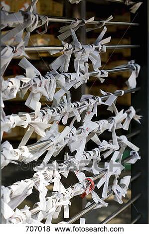Stock Photo - Prayers tied to a rack at Japanese temple. Fotosearch