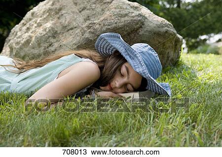 A girl lying in grass View Large Photo Image Stock Image - A girl lying in grass. Fotosearch