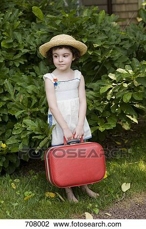 A young girl holding a suitcase waiting View Large Photo Image Stock Image - A young girl holding a suitcase waiting. Fotosearch