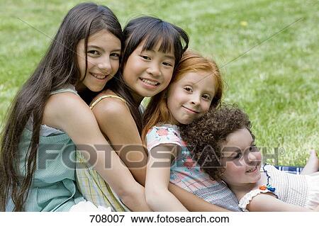 Four girls leaning on each other View Large Photo Image Stock Photo - Four girls leaning on each other. Fotosearch