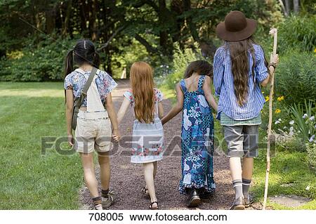 Four girls walking down a path View Large Photo Image Stock Photography - Four girls walking down a path. Fotosearch