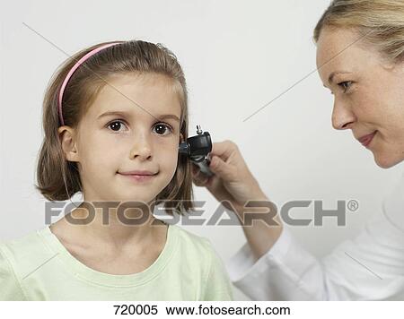 A female pediatrician using an otoscope to exam a girl's ear View Large Photo Image Stock Photography - A female pediatrician using an otoscope to exam a girl's ear. Fotosearch