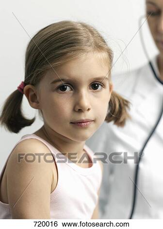 A young girl getting a medical Exam View Large Photo Image Stock Photograph - A young girl getting a medical Exam. Fotosearch