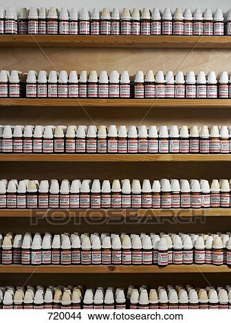 Picture - Rows of homeopathic globule bottles. Fotosearch