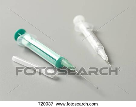 Stock Photo - Still Life of two syringes a syringe cap. Fotosearch