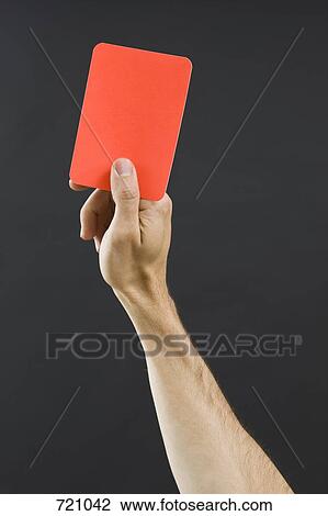 Stock Image - A hand holding a red card. Fotosearch