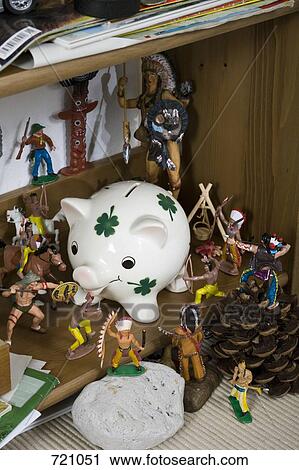 A large group of Native American figurines fighting over a piggy bank View Large Photo Image Stock Image - A large group of Native American figurines fighting over a piggy bank. Fotosearch