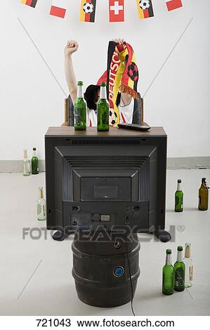 A person watching sport on television with beer bottles around View Large Photo Image Stock Image - A person watching sport on television with beer bottles around. Fotosearch