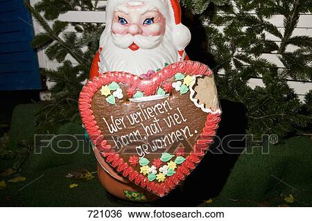 A Santa Claus figurine holding a Lebkuchen View Large Photo Image Stock Photograph - A Santa Claus figurine holding a Lebkuchen. Fotosearch
