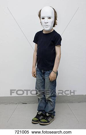 Stock Photography - A young boy wearing a mask. Fotosearch