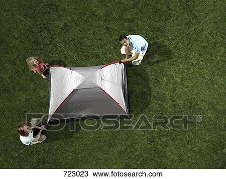 A family putting up a tent on grass View Large Photo Image Stock Image - A family putting up a tent on grass. Fotosearch