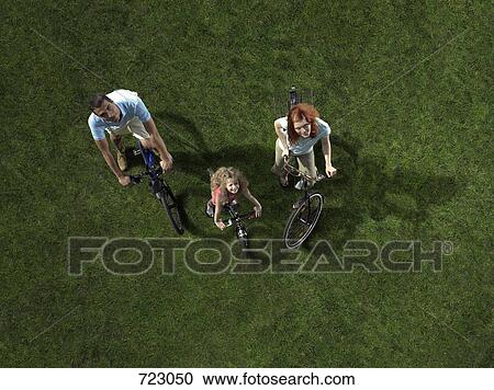 A family riding bicycles View Large Photo Image Stock Image - A family riding bicycles. Fotosearch