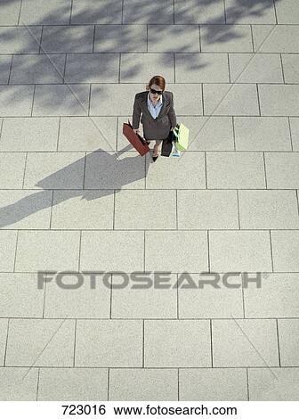 A woman carrying shopping bags View Large Photo Image Stock Photograph - A woman carrying shopping bags. Fotosearch
