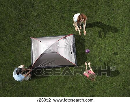A young family putting up a tent and playing with a ball View Large Photo Image Stock Image - A young family putting up a tent and playing with a ball. Fotosearch