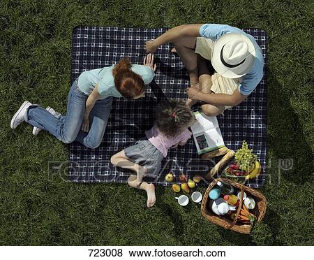 Family having a picnic on grass View Large Photo Image Stock Photo - Family having a picnic on grass. Fotosearch