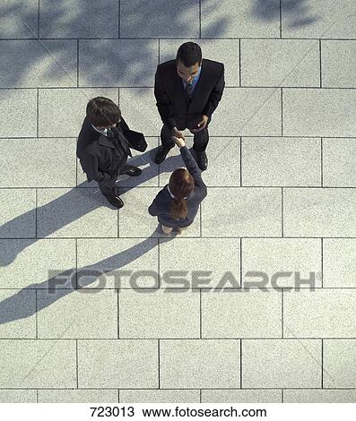 Three business people shaking hands View Large Photo Image Stock Image - Three business people shaking hands. Fotosearch