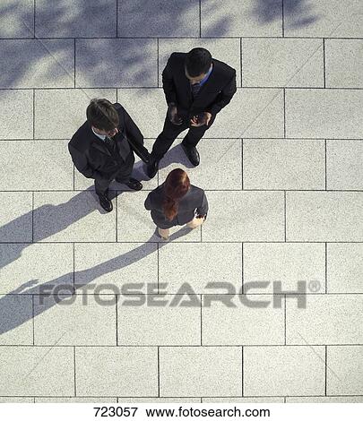 Three business people talking outdoors View Large Photo Image Stock Photo - Three business people talking outdoors. Fotosearch