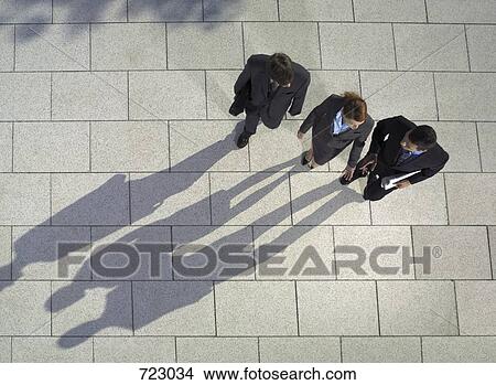 Three business people walking View Large Photo Image Picture - Three business people walking. Fotosearch