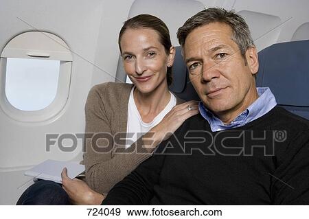 Stock Photo - A couple sitting on a plane. Fotosearch