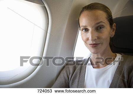A female passenger on a plane, portrait View Large Photo Image Stock Image - A female passenger on a plane, portrait. Fotosearch