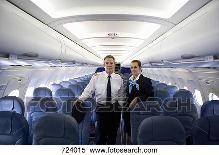 A pilot and a flight attendant standing in the cabin of a plane View Large Photo Image Stock Photography - A pilot and a flight attendant standing in the cabin of a plane. Fotosearch