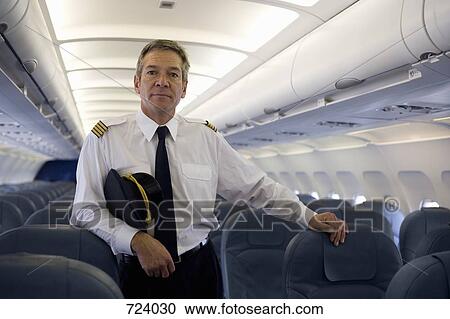 A pilot standing in the cabin of a plane View Large Photo Image Stock Image - A pilot standing in the cabin of a plane. Fotosearch