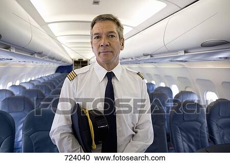 A pilot standing in the cabin of a plane View Large Photo Image Stock Image - A pilot standing in the cabin of a plane. Fotosearch