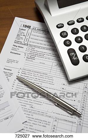 A calculator and pen on top of a tax return form View Large Photo Image Stock Photo - A calculator and pen on top of a tax return form. Fotosearch