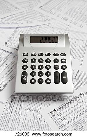 A calculator on top of tax return forms View Large Photo Image Stock Image - A calculator on top of tax return forms. Fotosearch
