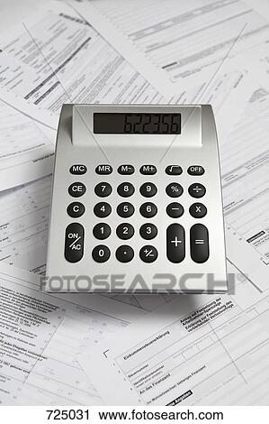 A calculator on top of tax return forms View Large Photo Image Stock Image - A calculator on top of tax return forms. Fotosearch