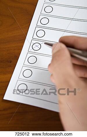 Stock Image - A person filling in a form. Fotosearch