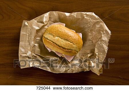 A sandwich sitting on a brown paper bag View Large Photo Image Picture - A sandwich sitting on a brown paper bag. Fotosearch