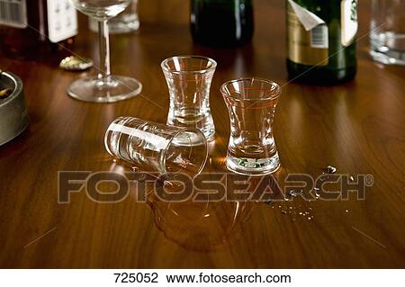 A table cluttered with shot glasses and bottles View Large Photo Image Stock Image - A table cluttered with shot glasses and bottles. Fotosearch