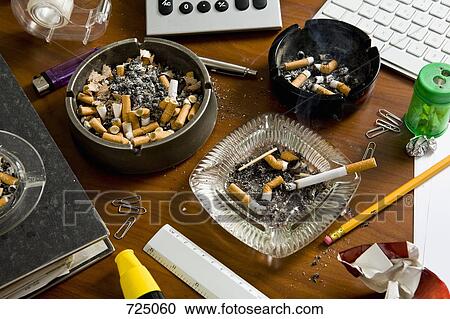 An office desk cluttered with office supplies and ashtrays View Large Photo Image Stock Image - An office desk cluttered with office supplies and ashtrays. Fotosearch