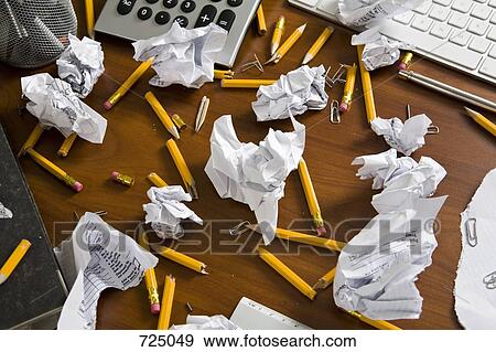 An office desk cluttered with pencils and crumpled paper View Large Photo Image Stock Photo - An office desk cluttered with pencils and crumpled paper. Fotosearch