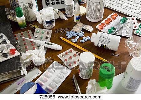 An office desk cluttered with various medicines View Large Photo Image Stock Photograph - An office desk cluttered with various medicines. Fotosearch