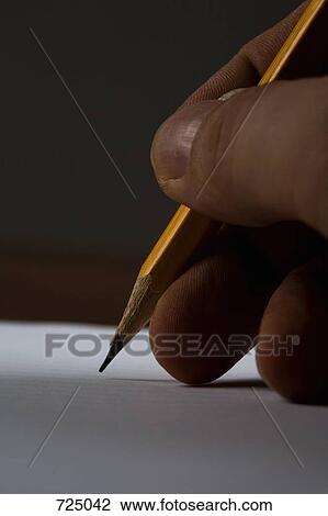 Extreme close-up of a handing holding a pencil View Large Photo Image Stock Image - Extreme close-up of a handing holding a pencil. Fotosearch