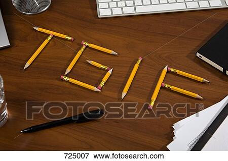 Stock Photo - Pencils on a desk arranged to spell TGIF. Fotosearch