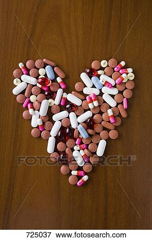 Pills arranged in a heart shape View Large Photo Image Stock Photo - Pills arranged in a heart shape. Fotosearch