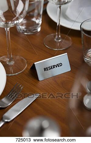Stock Image - Reserved Sign on a dining table. Fotosearch