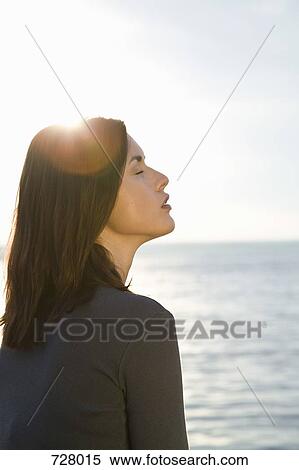 A woman sitting by the sea View Large Photo Image Stock Photography - A woman sitting by the sea. Fotosearch