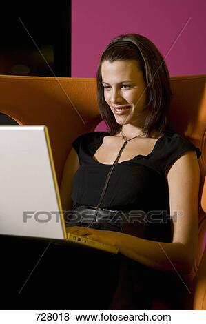 Stock Photo - A woman using a laptop . Fotosearch