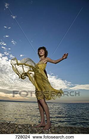A woman with her arms raised and carefree View Large Photo Image Picture - A woman with her arms raised and carefree. Fotosearch