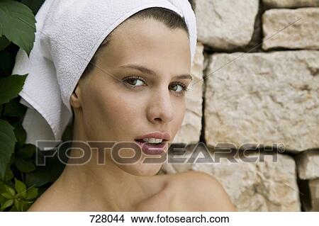 A woman with her hair wrapped in a towel View Large Photo Image Picture - A woman with her hair wrapped in a towel. Fotosearch