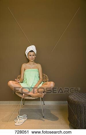 A woman wrapped in a towel listening to a MP3 player View Large Photo Image Stock Image - A woman wrapped in a towel listening to a MP3 player. Fotosearch
