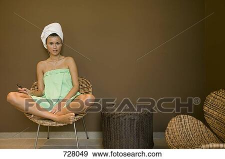 A woman wrapped in a towel listening to a MP3 player View Large Photo Image Stock Photo - A woman wrapped in a towel listening to a MP3 player. Fotosearch