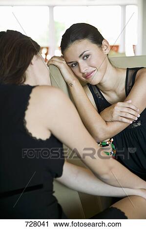 Stock Image - Two women bonding together. Fotosearch