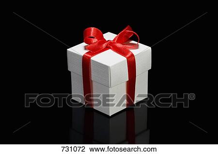 A gift box with a red ribbon View Large Photo Image Stock Image - A gift box with a red ribbon. Fotosearch