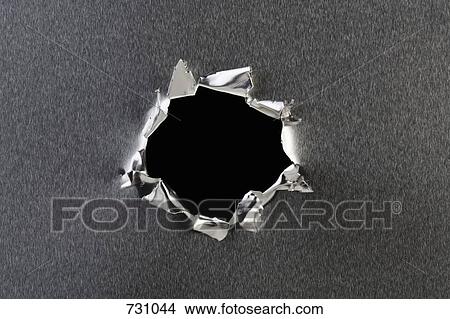 Picture - A hole in metal. Fotosearch