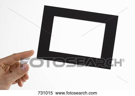 A human hand adjusting a slanted picture frame View Large Photo Image Stock Photography - A human hand adjusting a slanted picture frame. Fotosearch